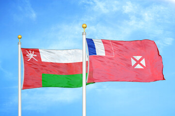 Naklejka na ściany i meble Oman and Wallis and Futuna two flags on flagpoles and blue sky