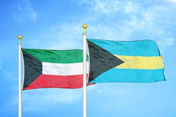 Kuwait and Bahamas two flags on flagpoles and blue sky
