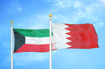 Kuwait and Bahrain two flags on flagpoles and blue sky