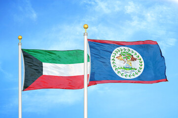 Kuwait and Belize two flags on flagpoles and blue sky