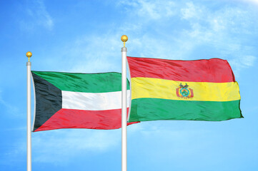 Kuwait and Bolivia two flags on flagpoles and blue sky