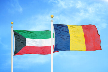 Kuwait and Chad two flags on flagpoles and blue sky