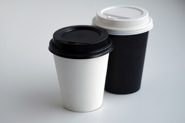  two white-black plastic coffee cups