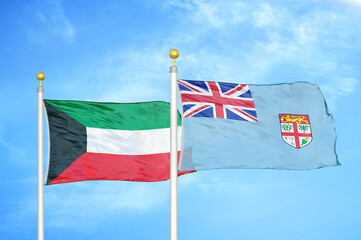 Kuwait and Fiji two flags on flagpoles and blue sky