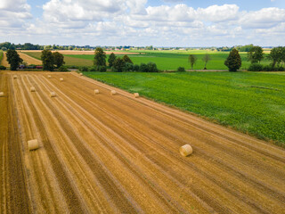 Bales of hay on the field after harvest shot by drone. Aerial drone photo of Poland country