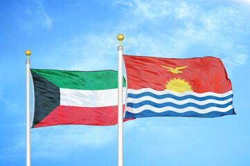 Fototapeta na wymiar Kuwait and Kiribati two flags on flagpoles and blue sky