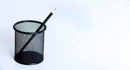 Black pencil on a light background, graphic pencil, glass for pencils