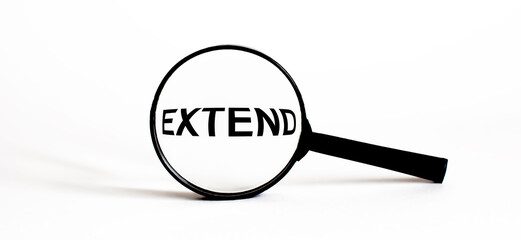 Magnifier with text EXTEND on the white background