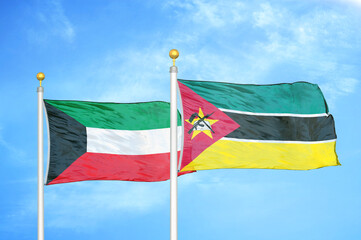 Kuwait and Mozambique two flags on flagpoles and blue sky