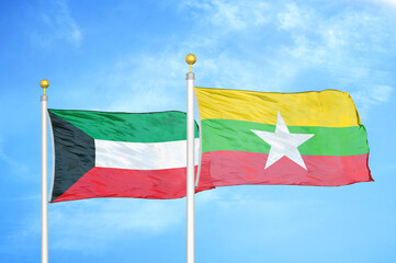 Kuwait and Myanmar two flags on flagpoles and blue sky