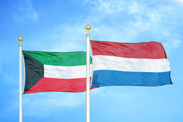 Naklejka na ściany i meble Kuwait and Netherlands two flags on flagpoles and blue sky