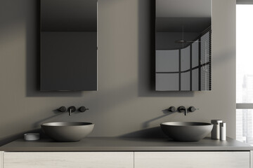 Fototapeta na wymiar Two round sinks in grey bathroom