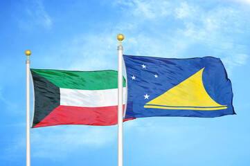 Kuwait and Tokelau two flags on flagpoles and blue sky
