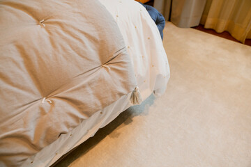 Obraz na płótnie Canvas close up soft bed blanket and fur carpet rug near window bedroom