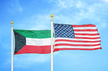 Kuwait and United States two flags on flagpoles and blue sky