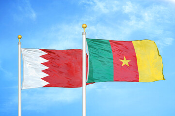 Bahrain and Cameroon two flags on flagpoles and blue sky