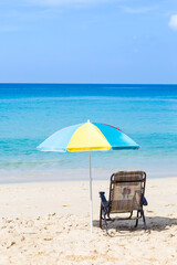 Colorful beach umbrella on beautiful beach, summer outdoor day light, relaxing by the sea, summer break