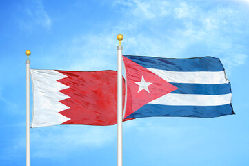 Bahrain and Cuba two flags on flagpoles and blue sky