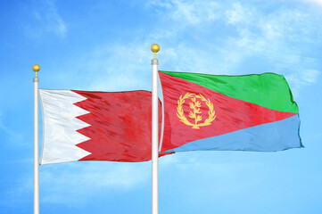 Bahrain and Eritrea two flags on flagpoles and blue sky