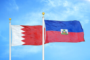 Bahrain and Haiti two flags on flagpoles and blue sky