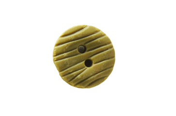 An old battered beige sewing button close-up isolated on a white background.