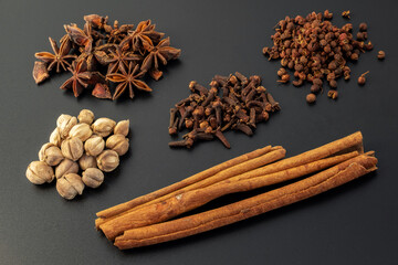 Assorted colorful spices on a black background. Healthy diet lifestyle.