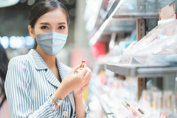 New normal lifestyle asian female blue shirt wear protecting mask shopping in department store after end of lockdown quarantine period
