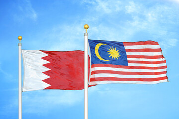 Bahrain and Malaysia two flags on flagpoles and blue sky