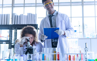Discover COVID-19 or Corona virus vaccine. Young scientists biologists or researchers putting...