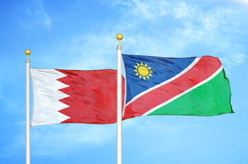 Naklejka na ściany i meble Bahrain and Namibia two flags on flagpoles and blue sky
