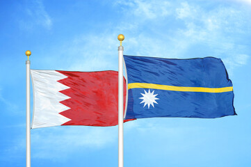 Bahrain and Nauru two flags on flagpoles and blue sky