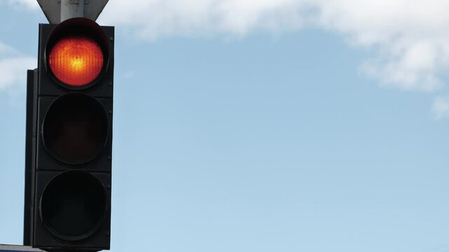 Traffic light on sky background. High quality 4k footageTraffic light for drivers on a background of blue sky. International traffic light day