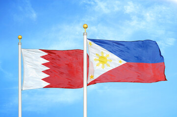 Bahrain and Philippines two flags on flagpoles and blue sky