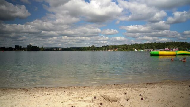 Kryspinow, South Poland - August 01, 2020: A family of father and son enjoying in the lake in summer