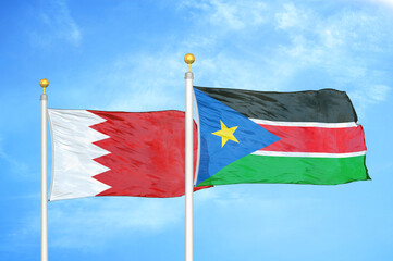 Bahrain and South Sudan two flags on flagpoles and blue sky