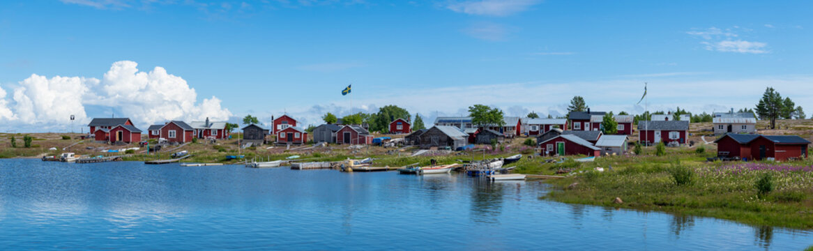 Traditional Fishing Village and Boat houses by the lake in Sweden on Stor-Rabben Island, Near Pitea in the Archipelago of Gulf of Bothnia in Northern Scandinavia.