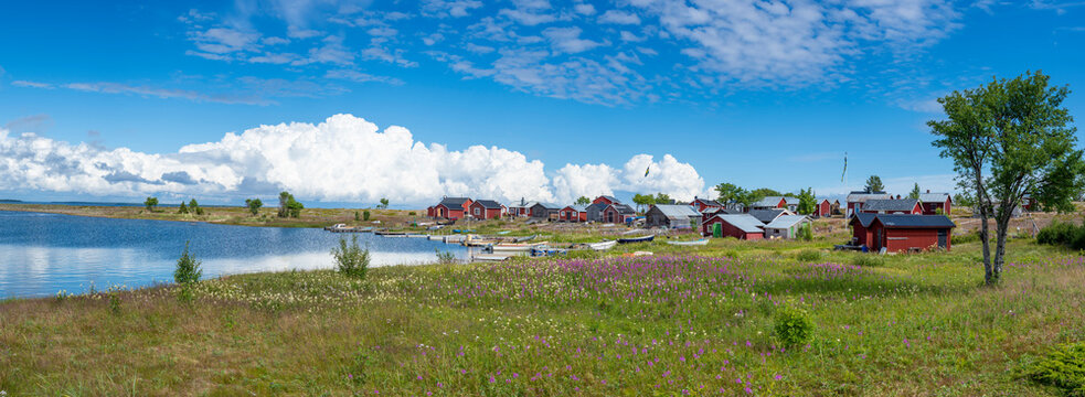 Traditional Fishing Village and Boat houses by the lake in Sweden on Stor-Rabben Island, Near Pitea in the Archipelago of Gulf of Bothnia in Northern Scandinavia.