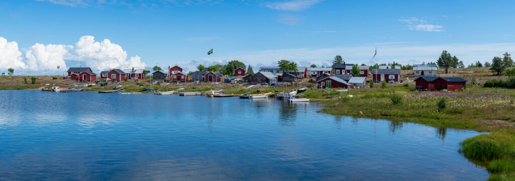 Traditional Fishing Village and Boat houses by the lake in Sweden on Stor-Rabben Island, Near Pitea in the Archipelago of Gulf of Bothnia in Northern Scandinavia.
