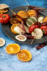Beautiful food portrait of Wnter seasonal dried fruits with old vintage texture background and cutlery and accessories