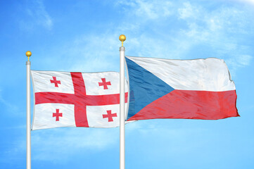 Georgia and Czech Republic two flags on flagpoles and blue sky