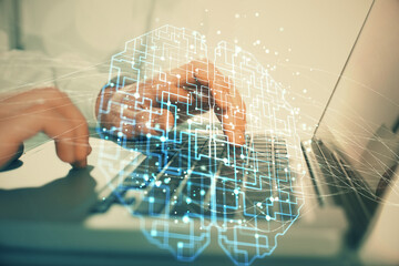 Man typing on keyboard background with brain hologram. Concept of big Data.