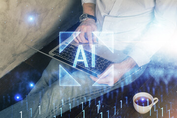 Multi exposure of data internet theme hologram with man working on computer on background. Concept of innovation.