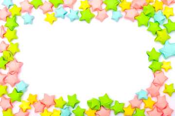 Frame of colorful paper stars in a children's style with an empty white place for text or image in the center