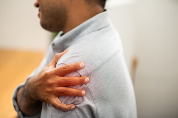 A man has a great shoulder pain Because he works after lifting heavy things He must be treated...