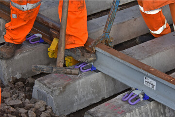 a pandrol type clip being installed on a new section of rail track