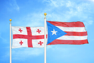 Georgia and Puerto Rico two flags on flagpoles and blue sky