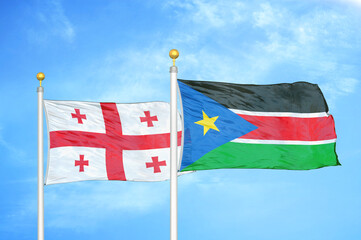 Georgia and South Sudan two flags on flagpoles and blue sky