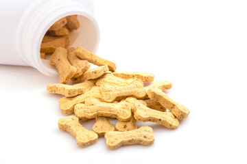 Pile of calcium for dog in white bottle isolated on white background