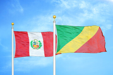 Peru and Congo two flags on flagpoles and blue sky