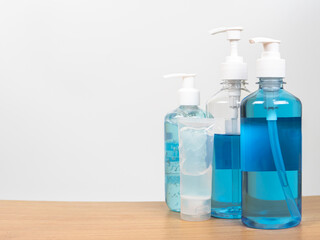 Alcohol gel bottles or hand sanitizer on blue background. This gel cleansers for antibacterial and virus for good sanitation hygiene.